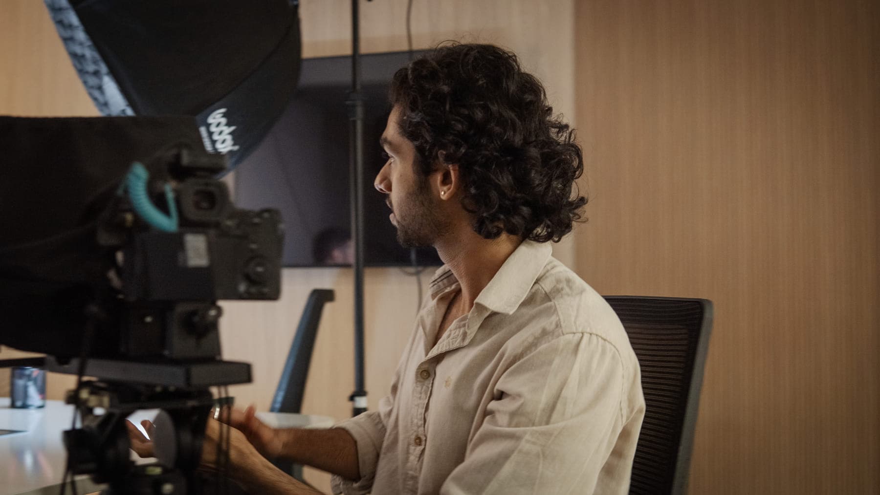 A GenC student behind a camera rig during a shoot at the studio